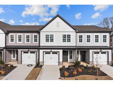 Newly built townhomes featuring modern designs, individual garages, and tastefully landscaped front yards at 707 Jamescroft Way, Rolesville, NC 27587