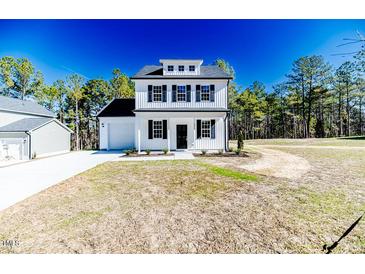 Charming two-story home with white siding, black shutters, and manicured lawn at 806 Roberts Rd, Sanford, NC 27332