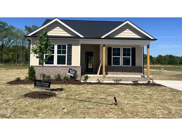 Inviting home featuring a brick foundation and covered porch at 155 Waterwheel Dr, Selma, NC 27576