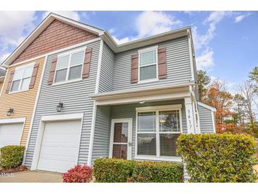 Charming two-story home featuring vinyl siding, shutters, front porch, and attached garage at 3417 Cardinal Lake Dr, Durham, NC 27704