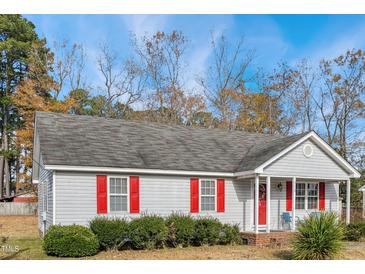 Gray house with red shutters, a covered porch, and landscaping at 512 Drexel Rd, Rocky Mount, NC 27803
