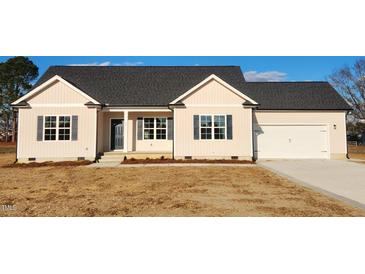 Newly built single-story house with neutral siding and a two-car garage at 52 Roll Tide Ct, Angier, NC 27501