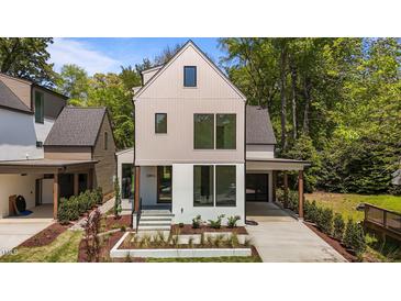 Modern home featuring a two-tone exterior, large windows, minimalist landscaping, and a covered carport at 339 1/2 Mulberry St, Raleigh, NC 27604