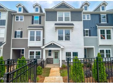 Charming townhouse with a well-manicured lawn and black metal fence at 207 Pond View Ct # 3, Fuquay Varina, NC 27526