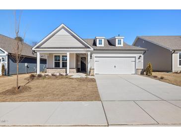 Charming single-Gathering home with a two-car garage and well-manicured front yard in a suburban neighborhood at 2317 Forsythia Trl, Fuquay Varina, NC 27526