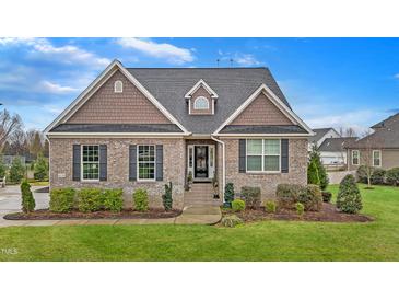Charming brick home with well-manicured landscaping and a classic architectural design in a suburban neighborhood at 4236 Aviemore, Burlington, NC 27215