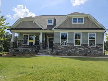 Charming home featuring stone accents, neutral siding, and inviting front porch at 200 Ironwood Lot 39 Blvd, Youngsville, NC 27596