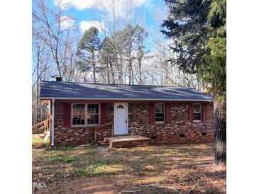 Brick ranch house with red shutters, and a small front porch at 2800 Coleman Loop Rd, Hillsborough, NC 27278