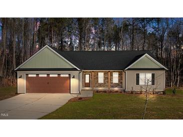 Charming single-story home featuring stone accents, a two-car garage, and inviting curb appeal at 125 Leisure Ln, Louisburg, NC 27549