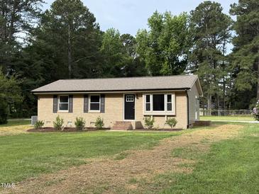 Charming single-story home with a brick facade, dark shutters, and a well-maintained front yard at 2253 Nc Highway 96 S, Franklinton, NC 27525