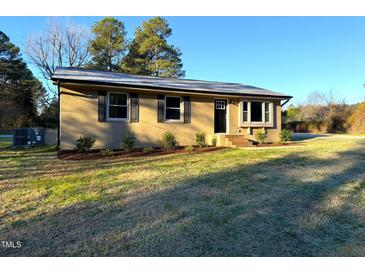 Ranch style home with a landscaped yard at 2253 Nc Highway 96 S, Franklinton, NC 27525