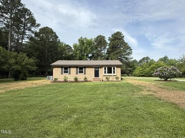 Charming single-story home with a manicured lawn and mature trees at 2253 Nc Highway 96 S, Franklinton, NC 27525