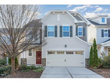 Charming two-story home featuring a red door, stone accents, and a two-car garage at 226 Begen St, Morrisville, NC 27560
