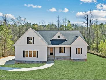 Beautiful new construction home with white siding, dark shutters, and professionally landscaped yard at 40 Moonraker Dr, Spring Hope, NC 27882
