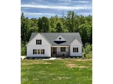 Charming home showcasing a bright green lawn and pristine white siding at 40 Moonraker Dr, Spring Hope, NC 27882