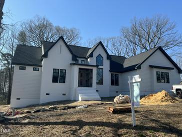 New two-story home featuring a white brick and siding exterior and black roof accents at 4804 Jefferson Ln, Raleigh, NC 27616