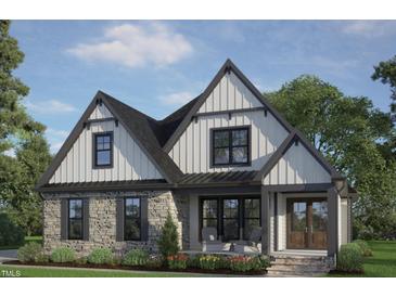 Charming two-story home with stone accents, black trim, and a welcoming front porch at 12 Cabin Crk, Pittsboro, NC 27312