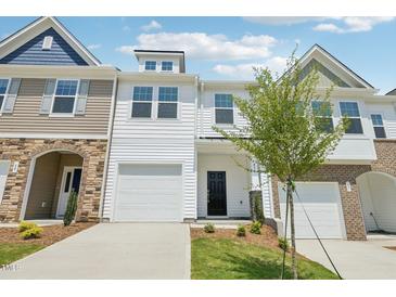 Charming townhouse with white siding, a one-car garage, and manicured front lawn at 43 Honeydew Way, Clayton, NC 27520