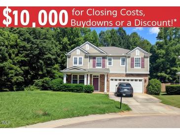 Charming two-story home with a well-manicured lawn and attached two car garage at 101 Clardona Way, Holly Springs, NC 27540