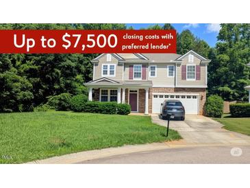 Charming two-story home with a manicured lawn, attached garage, and mature trees, offering a welcoming curb appeal at 101 Clardona Way, Holly Springs, NC 27540