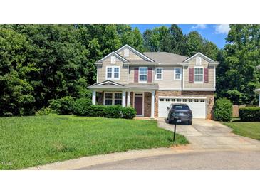 Charming two-story home with stone accents, neutral siding, red shutters, and a two-car garage at 101 Clardona Way, Holly Springs, NC 27540
