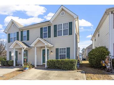 Charming townhome featuring a manicured lawn, neutral siding, green shutters, and a concrete driveway at 2248 Ventana Ln, Raleigh, NC 27604