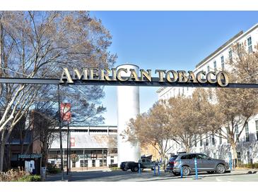 American Tobacco Campus entrance featuring a sign with gold lettering and various shops and buildings at 600 S Duke St # 26, Durham, NC 27701
