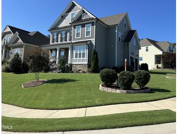 Two-story house with gray siding, stone accents, and a landscaped lawn at 503 Bendemeer Ln, Rolesville, NC 27571
