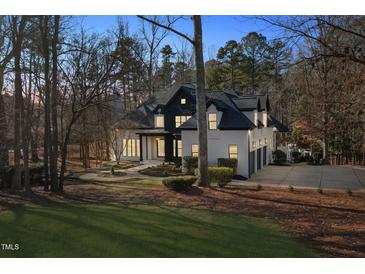 Stunning two-story home with a black and white exterior, nestled among trees at 6701 Green Hollow Ct, Wake Forest, NC 27587