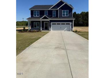 Charming navy two-story home with a spacious driveway and well-maintained front lawn at 23 Surles Landing Way, Benson, NC 27504