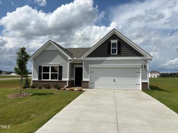 Charming single-story home with gray siding, a two-car garage, and a well-maintained lawn at 17 E Victory View Ter, Smithfield, NC 27577