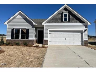 Charming single-Gathering home featuring a two-car garage and neutral color scheme at 17 E Victory View Ter, Smithfield, NC 27577
