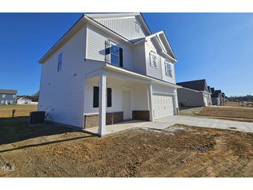 Two-story house with white siding, brick accents, and a covered porch at 216 Vili Dr, Broadway, NC 27505