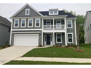 Charming two-story home with gray siding, white trim, covered porch, and a well-maintained lawn at 310 N Maple Walk # 236, Garner, NC 27529