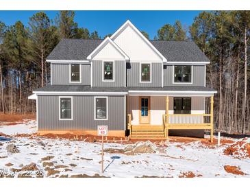 Two-story house with gray siding, white accents, and a covered porch at 80 Purslane Dr, Franklinton, NC 27525