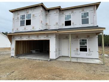 Two-story home with a two-car garage under construction with visible framework and wrap at 179 Deodora Ln, Cameron, NC 28326