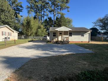 Newly renovated house with gravel driveway and small front yard at 222 Weston Rd, Garner, NC 27529