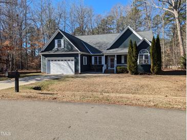 Gray house with white garage door and landscaping at 312 Ashwick Dr, Efland, NC 27243