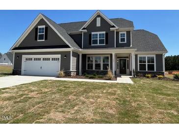 Beautiful two-story home with gray siding, well-maintained lawn, and a two-car garage at 467 Ravensworth Dr, Garner, NC 27529