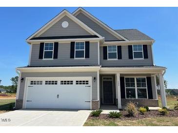 Charming two-story home featuring gray siding, black shutters and a two-car garage at 505 Ravensworth Dr, Garner, NC 27529