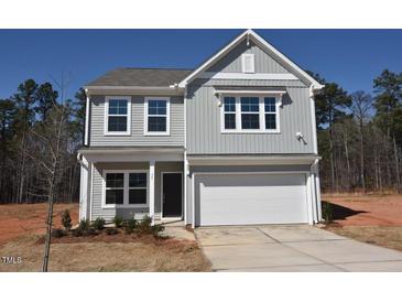 Charming two-story home featuring gray siding, white trim, and an attached two-car garage at 75 Calabria Ct, Franklinton, NC 27525