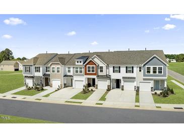 Exterior view of charming townhouses with attached garages and well-manicured lawns at 94 Clementine Street St # 174, Angier, NC 27501