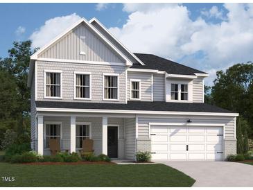 Two-story home with gray siding, a covered porch, and a two-car garage at 100 S Stonemill Trl # Homesite 234, Clayton, NC 27520