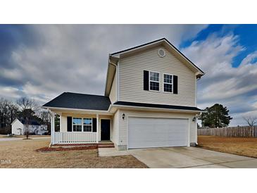 Two-story house with attached garage and landscaped yard at 15 Michael Ct, Erwin, NC 28339