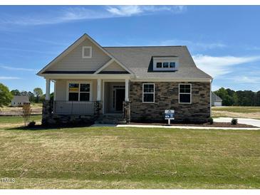 Charming single-Gathering home with a stone facade and a covered porch in a beautiful community at 292 Weddington Way, Benson, NC 27504