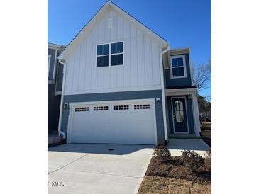 Two-story home with gray and white siding, two-car garage, and landscaping at 620 Brittany Ct, Durham, NC 27703