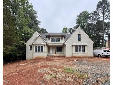 Charming new construction home featuring brick exterior, multiple windows, and a covered front porch at 8604 Windjammer Dr, Raleigh, NC 27615