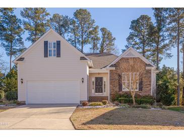 One-story house with stone and siding, a two-car garage, and landscaping at 1024 Bellenden Dr, Durham, NC 27713