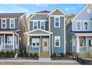 Two-story craftsman style home with light gray siding and a welcoming front porch at 144 Weavers Grove Dr, Chapel Hill, NC 27514