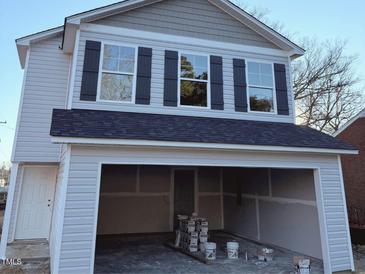 Two-story house with gray siding, black shutters, and attached garage at 204 S Beaumont Ave, Burlington, NC 27217